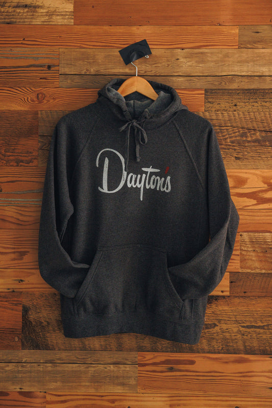 Black hoodie with 'Dayton' text on a wooden background