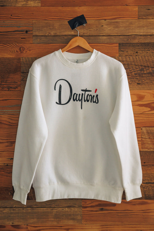 White sweatshirt with 'Dayton's' logo on a wooden background