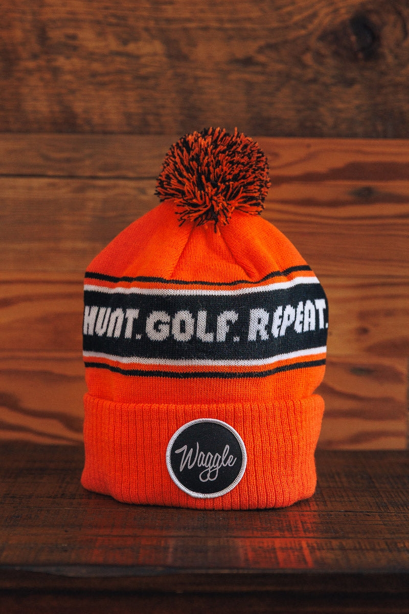 Orange beanie with text and logo on a wooden background