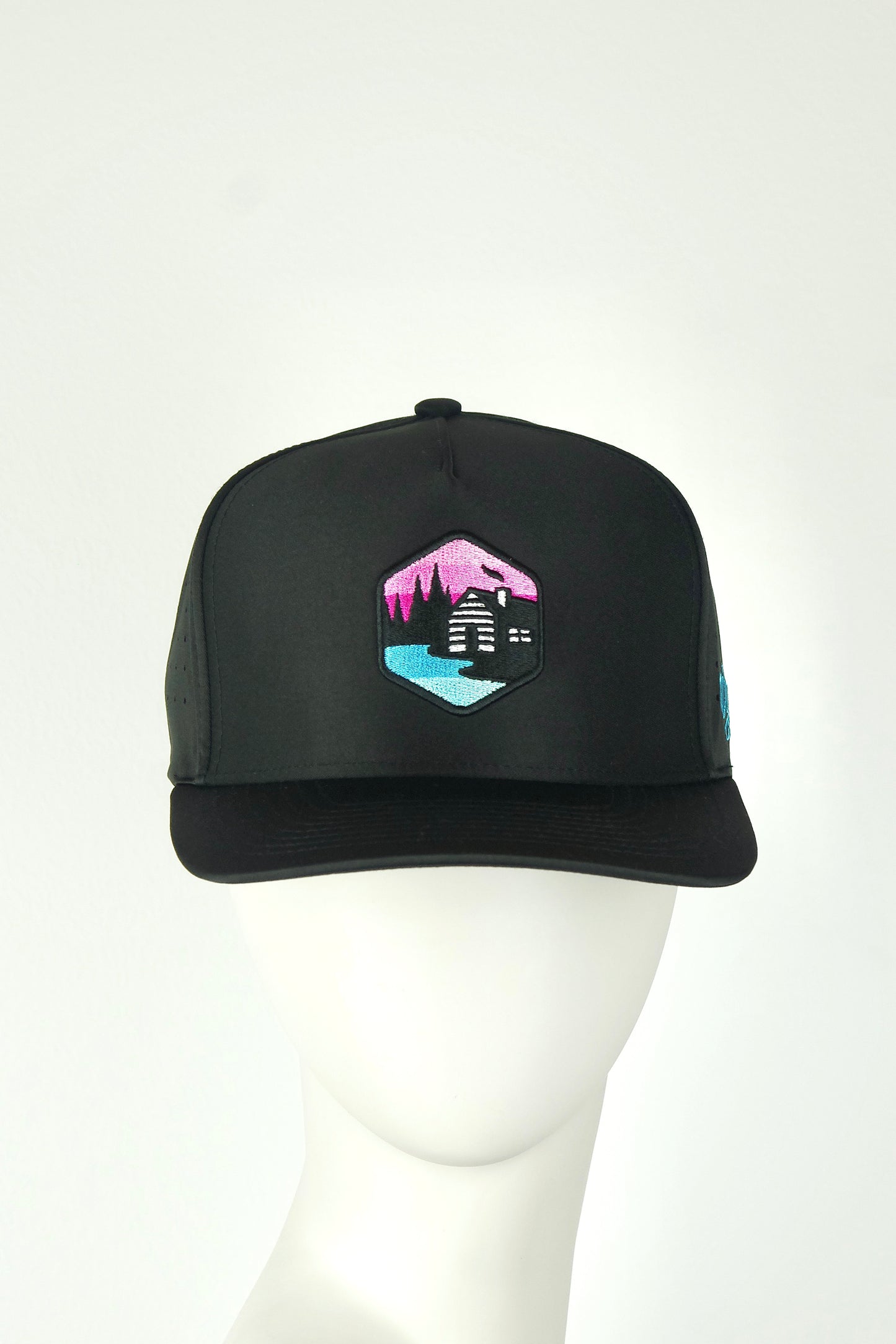 Black cap with a colorful embroidered sauna and sky on a white background