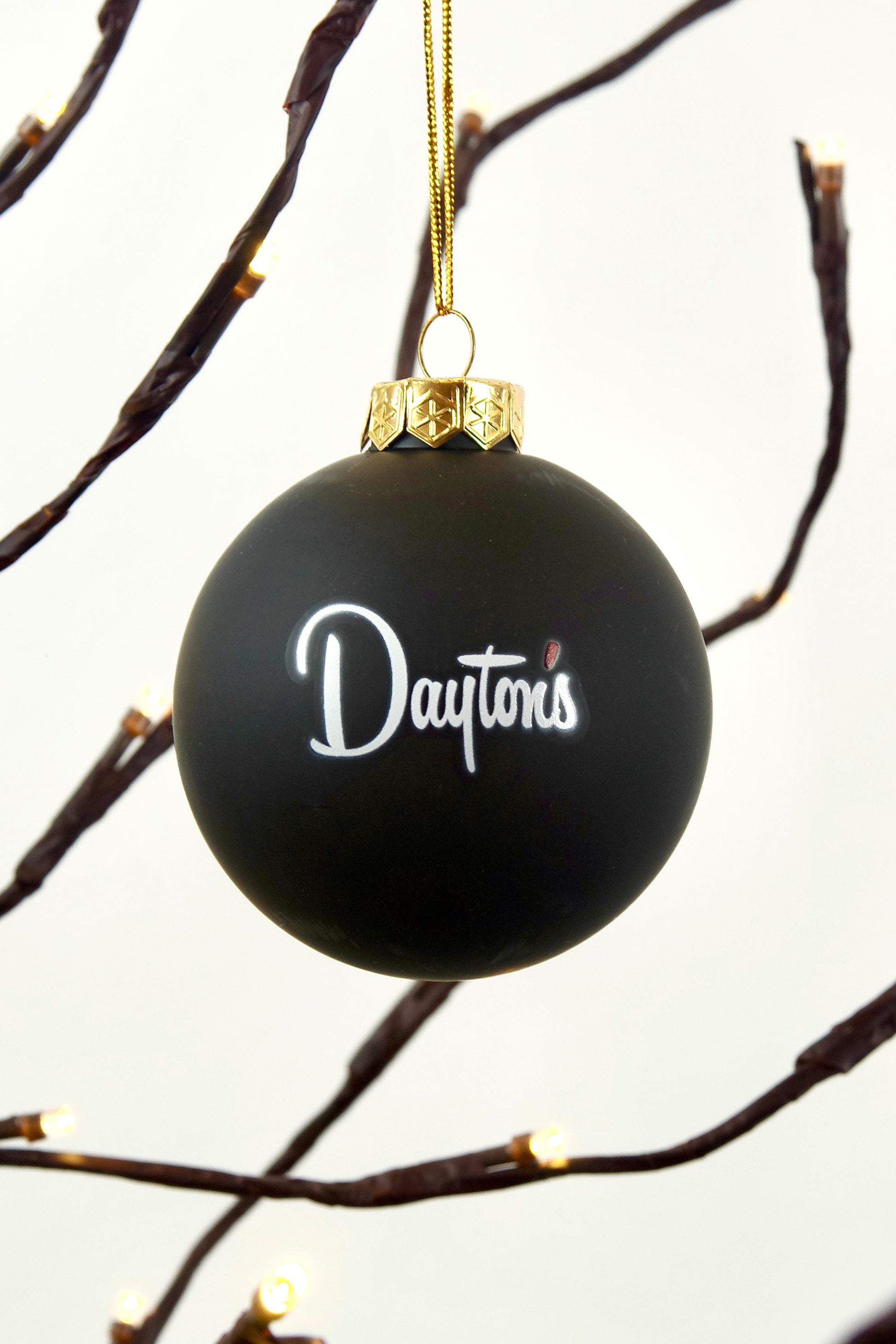 Black ornament with 'Dayton's' logo on a branch