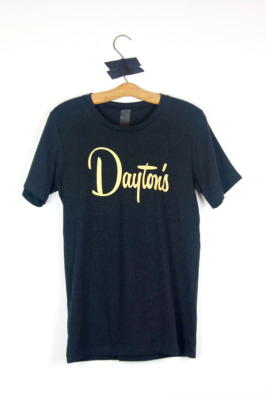 Black t-shirt with gold 'Dayton's' logo on a hanger against a white background