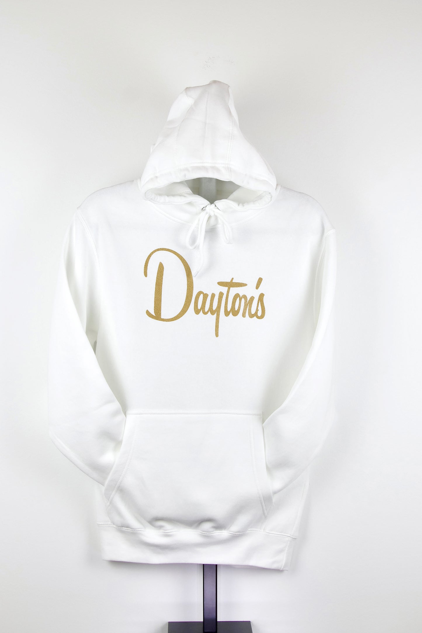 White hoodie with 'Dayton's' text in gold on a white background